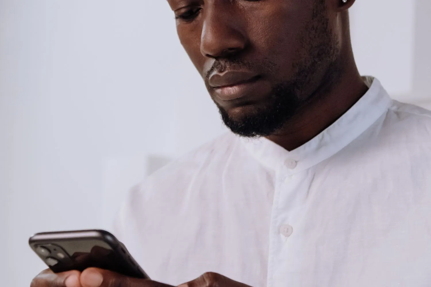 A person messaging from their phone in the evening
